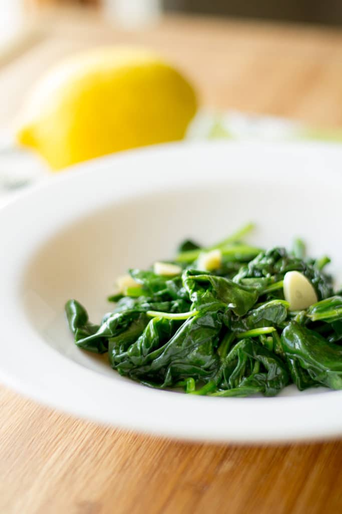 Spinach sautéed with lemon and garlic in a bowl.