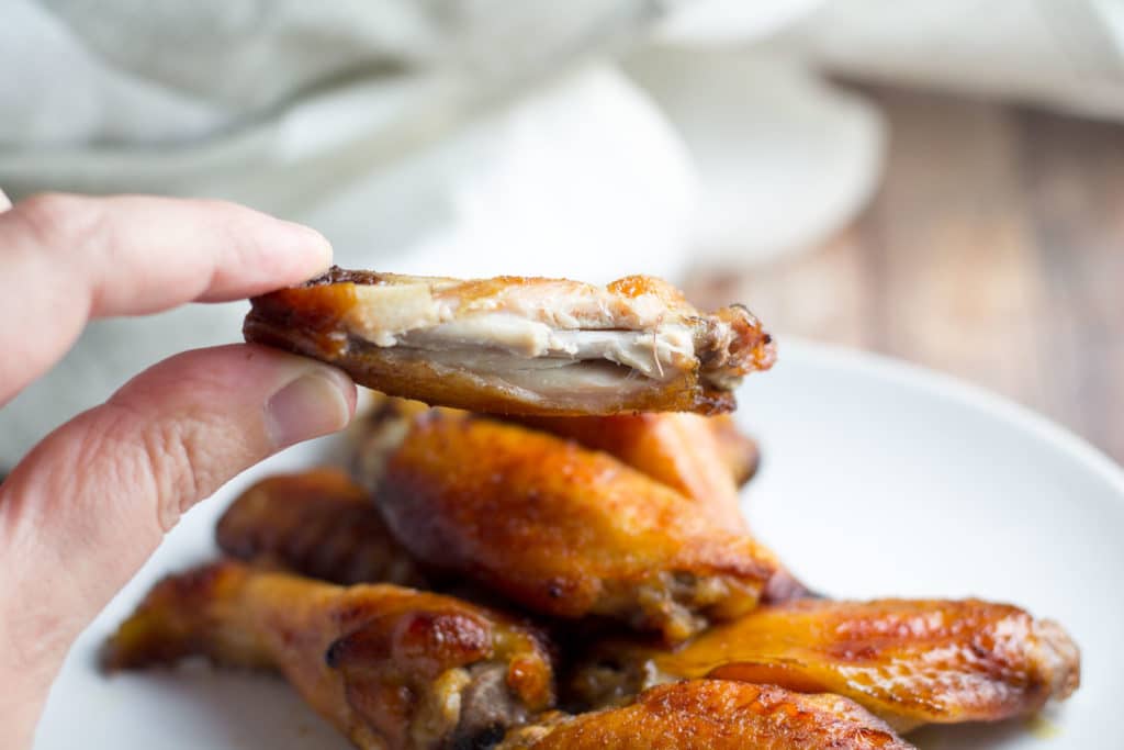 Asian Chicken Wing with a bite taken out of it