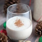 a glass of coquito on a table