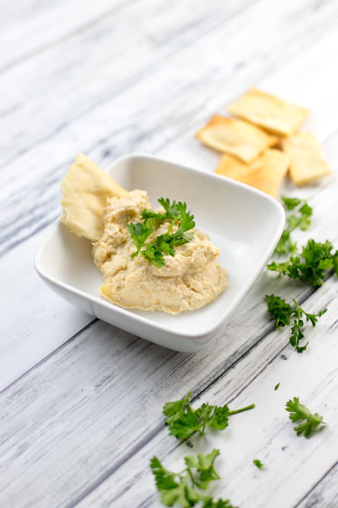 instant pot hummus in a dish with pita chips 
