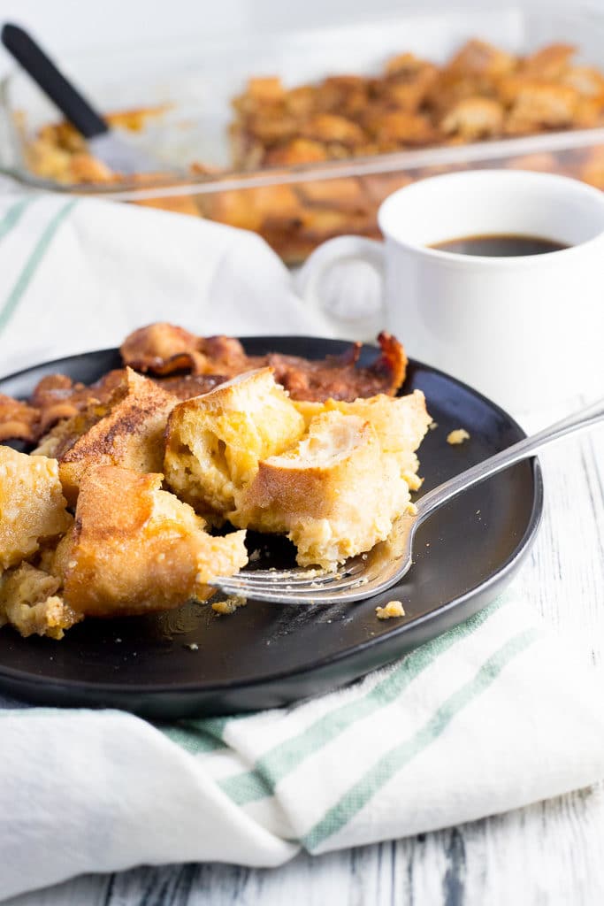 overnight french toast bake on a plate with bacon