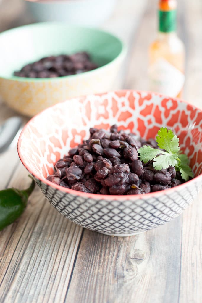 two bowls of instant pot black beans on a table
